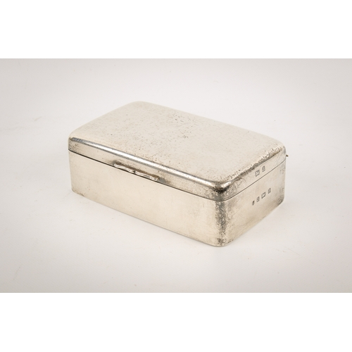 20A - An early 20th century silver cigarette box. Undecorated, with rounded corners and serpentine shallow... 