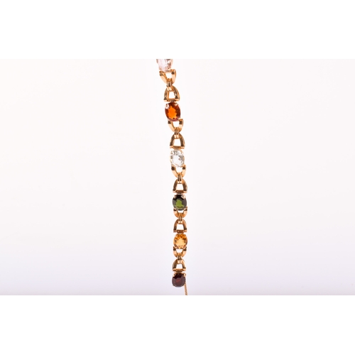 177 - A yellow metal stone set bracelet. Set with various oval cut stones in a cross link setting, includi... 