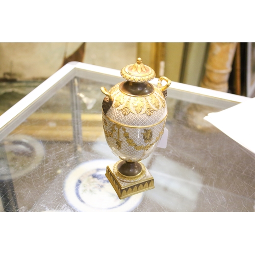149 - A late 19th/early 20th century Wedgwood gilt urn and cover. With Bacchus head and horn handles, deco... 
