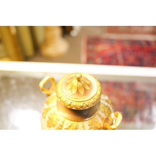 149 - A late 19th/early 20th century Wedgwood gilt urn and cover. With Bacchus head and horn handles, deco... 