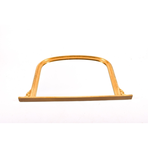 294 - An arched gilt framed overmantel mirror. Total H84cm x W127cm.