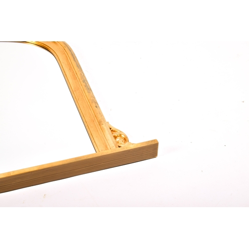 294 - An arched gilt framed overmantel mirror. Total H84cm x W127cm.