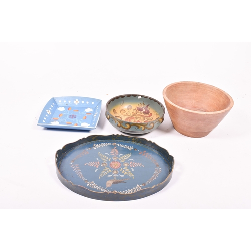 98 - Four wooden bowls and a tray. The majority with painted decoration, the tray of oval form with a gil... 