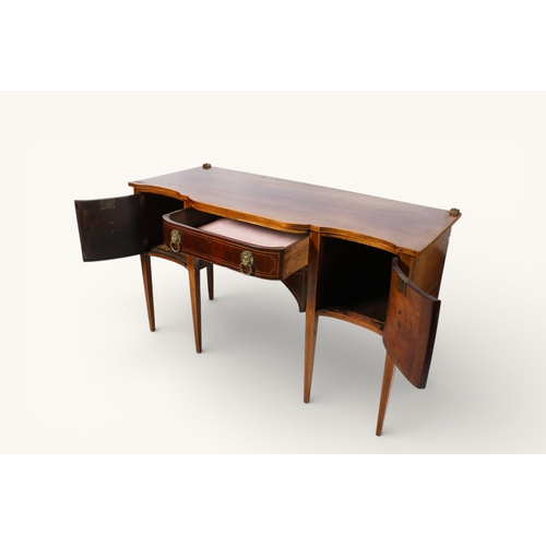 130 - A Georgian revival mahogany breakfront sideboard. Having a serpentine front, a single drawer flanked... 