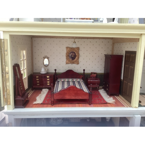 292 - A French style doll's house and contents. H75cm x W67cm x D25cm