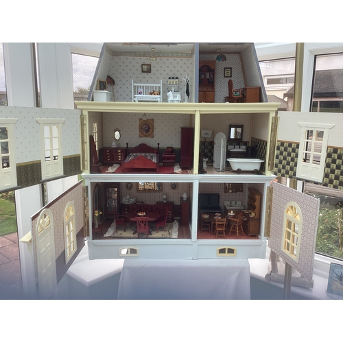 292 - A French style doll's house and contents. H75cm x W67cm x D25cm