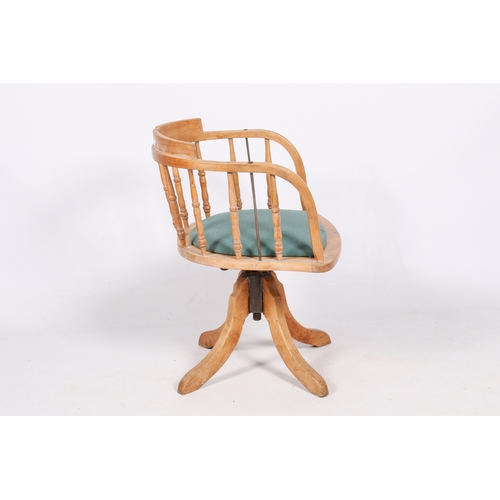 11 - A 20th century pine captain's chair. Curved backrest with turned spindles and drop in seat, upholste... 