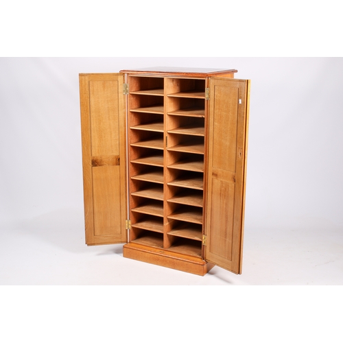 13 - A circa 1930s solid oak and pine cupboard. With pigeon hole style shelves to the interior. Moulded e... 