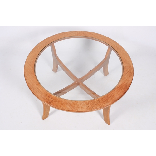 53 - A mid-century G-Plan style beech coffee table with inset glass top. H41cm x 83cm diameter