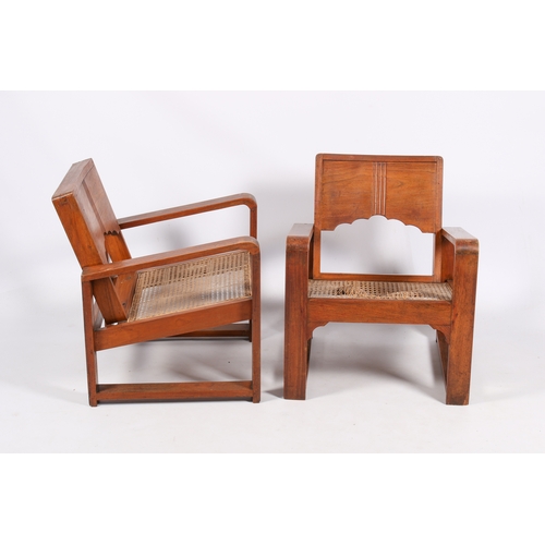 9 - A pair of 20th century Art Deco style teak armchairs. Shaped arms and backrest with wave edge and ca... 