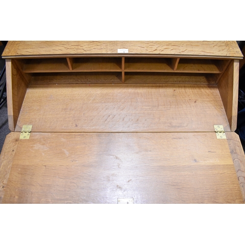 1 - Robert 'Mouseman' Thompson (British, 1876-1975) of Kilburn. A solid, light oak bureau with adzed top... 