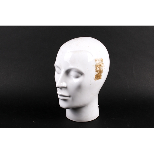 225 - A white glazed ceramic head modelled with short hair. H27cm