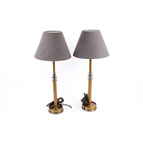 233 - A pair of contemporary Pooky Metro table lamps. Raised on circular bases. H47cm
