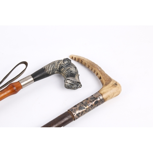 238 - A riding crop with hallmarked silver collars and a horn handle with a shoe horn with carved dog head... 