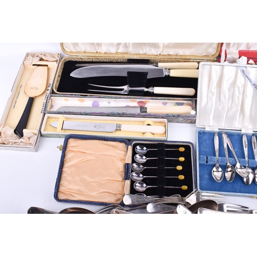 185 - A group of assorted flat and loose silver plated and stainless steel cutlery. Including a carving se... 
