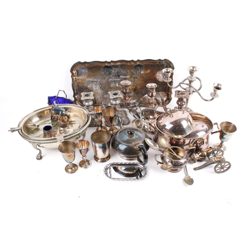 191 - A box of assorted silver plate. Including a pair of candlesticks, a tea pot and a tray, etc. Largest... 