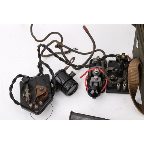 32 - An assortment of 20th century militaria. Comprising morse code tappers, a cut bayonet in a leather s... 