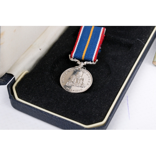 34 - A WWII medal and booklet group. Comprising two unmarked medals and a National Service medal with rib... 