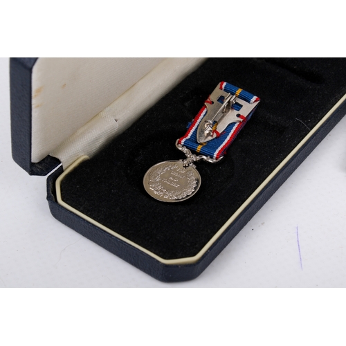 34 - A WWII medal and booklet group. Comprising two unmarked medals and a National Service medal with rib... 