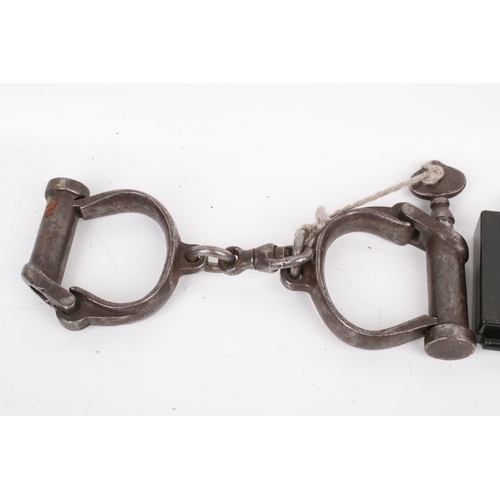 51 - Three 20th century military collectables. Comprising a pair of WWII Millitary Police handcuffs, date... 