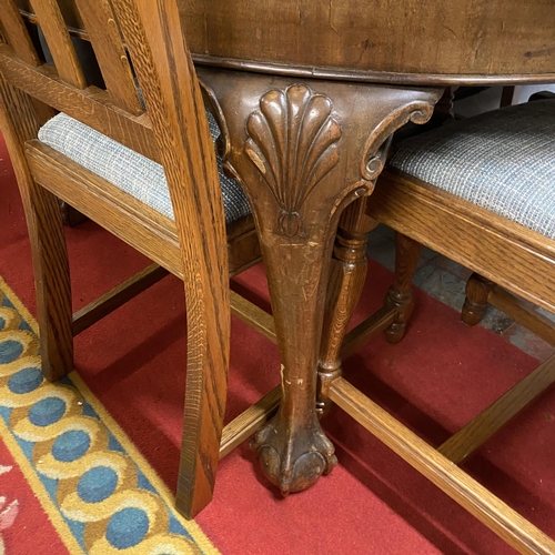 29 - Victorian ball and claw legged dining table with leaf and handle for wind and four oak high back din... 