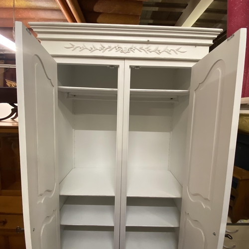 81 - White double wardrobe with ornate carvings on top with metal handles with keys