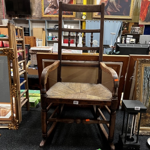 257 - Oak Edwardian rush bottom seated rocking chair with spindle back