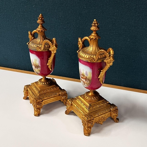 266 - Early gilt metal and porcelain Clock garniture set depicting Dutch scenes