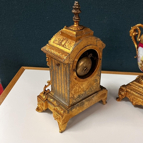 266 - Early gilt metal and porcelain Clock garniture set depicting Dutch scenes