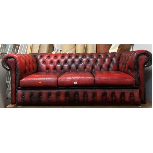 13 - Three seater Chesterfield settee in ox blood red leather