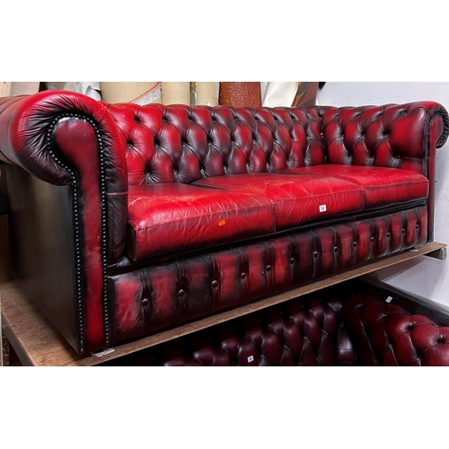 13 - Three seater Chesterfield settee in ox blood red leather