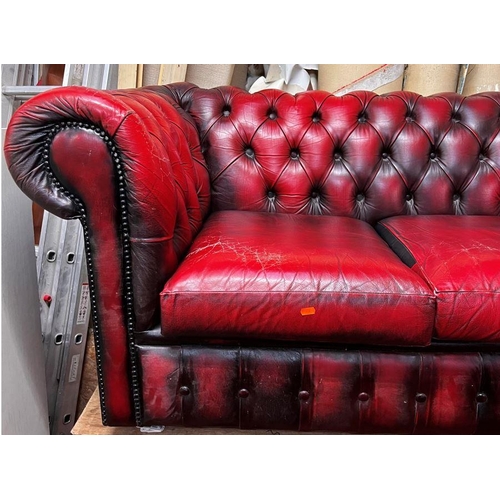 13 - Three seater Chesterfield settee in ox blood red leather