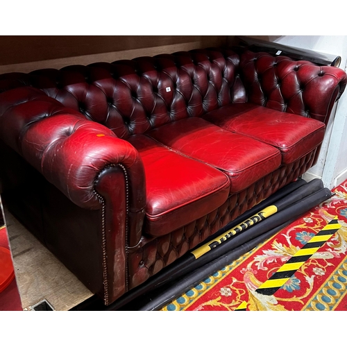 14 - Three seater Chesterfield settee in ox blood red leather