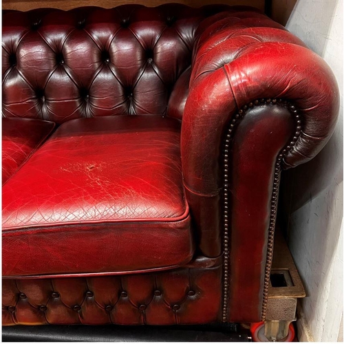 14 - Three seater Chesterfield settee in ox blood red leather