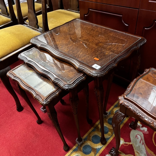 18 - Mahogany heavily carved nest of three tables with glass tops - with two other carved and glass top t... 