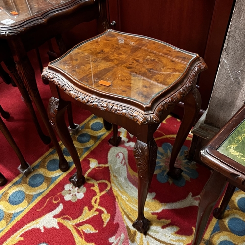 18 - Mahogany heavily carved nest of three tables with glass tops - with two other carved and glass top t... 