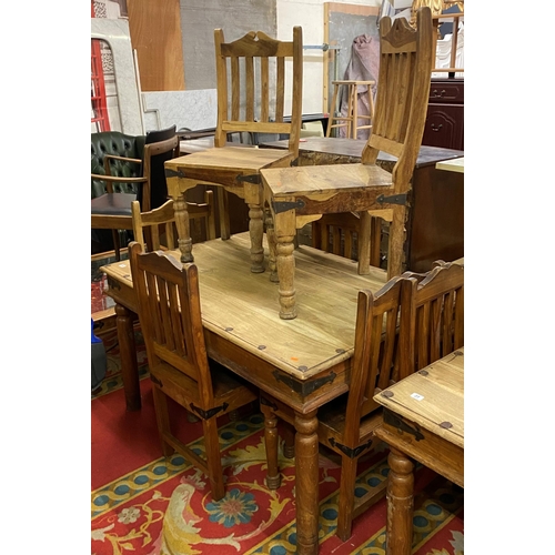 28 - Rustic table and six chairs with wrought iron corners and studded top