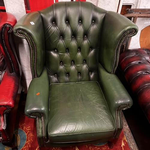 33 - Green leather Chesterfield winged back armchair on Queen Anne legs