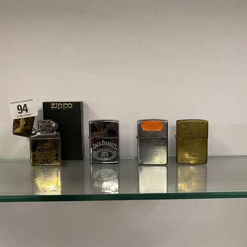 94 - Four zippos - one in presentation box and one representing Jack Daniels