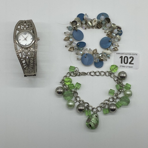 102 - Two ladies coloured stone charm bracelets and one cocktail watch