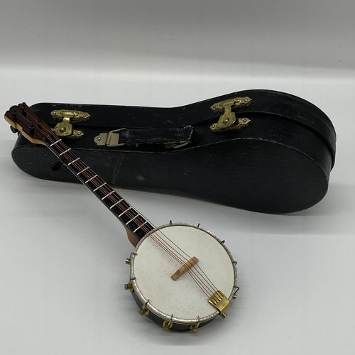 109 - 3D wood and metal string banjo in black velvet lined case