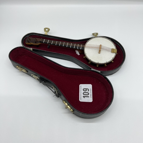 109 - 3D wood and metal string banjo in black velvet lined case