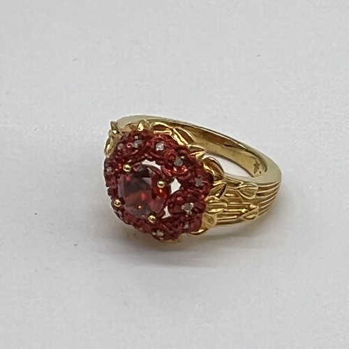 163 - Ladies gold tone ring with cranberry coloured stone, Size O