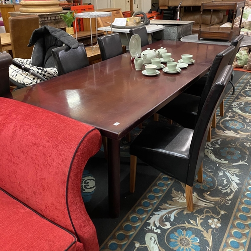 25 - Large mahogany dining table with six black leather diners