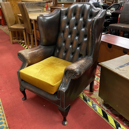 3 - Chesterfield winged back distressed armchair