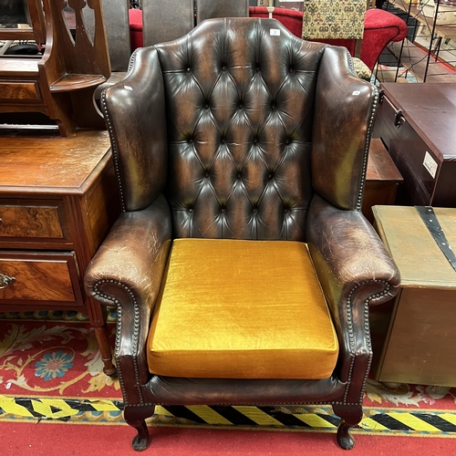 3 - Chesterfield winged back distressed armchair