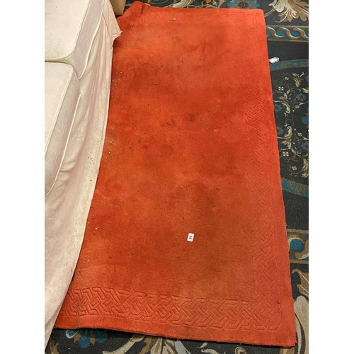 64 - Orange patterned rug