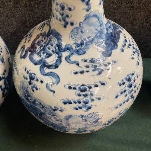 234 - Large pair of oriental blue and white dragon vases 18” tall