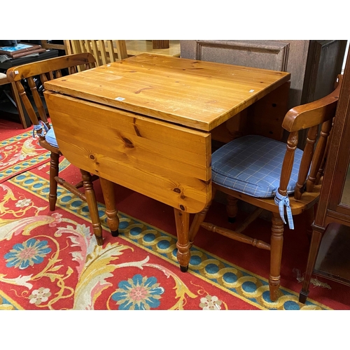 106 - Pine drop leaf table with two matching chairs