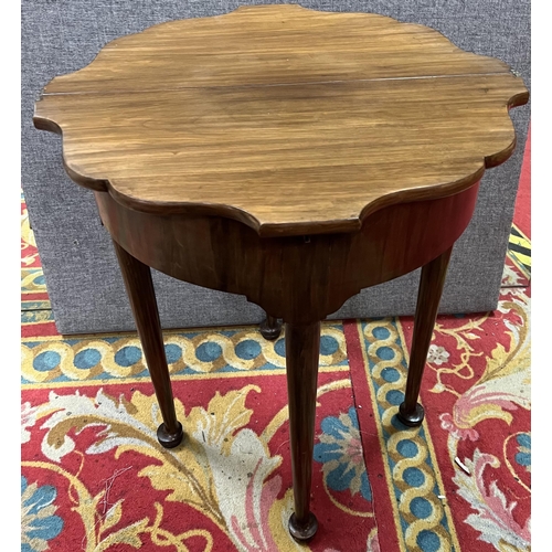 57 - Victorian flip top foot table in mahogany